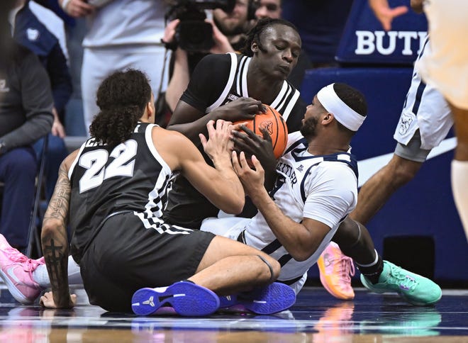 Feb 10, 2024; Indianapolis, Indiana, USA; Providence Friars guard Garwey Dual (3) and guard Devin Carter (22) and Butler Bulldogs guard Posh Alexander (5) battle for a loose ball during the first half at Hinkle Fieldhouse.
