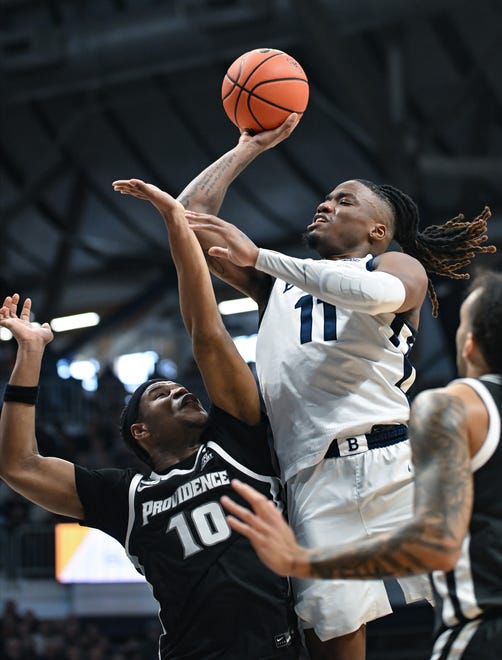 Feb 10, 2024; Indianapolis, Indiana, USA; Butler Bulldogs guard Jahmyl Telfort (11) makes a shot and is fouled by Providence Friars forward Rich Barron (10) during the first half at Hinkle Fieldhouse. Mandatory Credit: Robert Goddin-USA TODAY Sports
