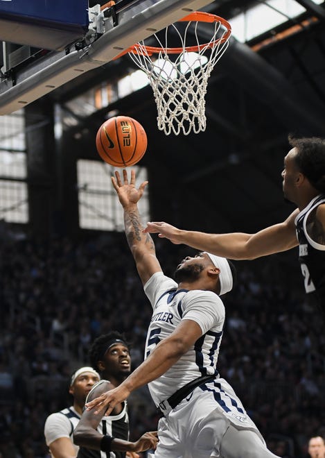 Feb 10, 2024; Indianapolis, Indiana, USA; Butler Bulldogs guard Posh Alexander (5) goes to the basket past Providence Friars guard Devin Carter (22) during the first half at Hinkle Fieldhouse. Mandatory Credit: Robert Goddin-USA TODAY Sports