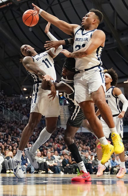 Feb 10, 2024; Indianapolis, Indiana, USA; Butler Bulldogs guards Jahmyl Telfort (11) and Pierre Brooks (21) battle Providence Friars guard Davonte Gaines (0) for a rebound during the second half at Hinkle Fieldhouse. Mandatory Credit: Robert Goddin-USA TODAY Sports