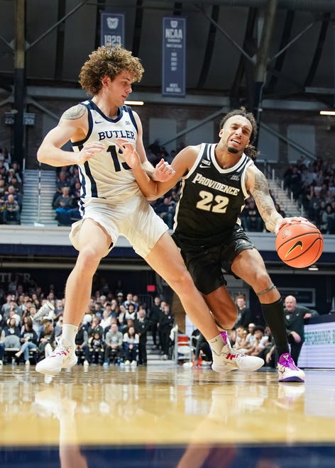 Feb 10, 2024; Indianapolis, Indiana, USA; Providence Friars guard Devin Carter (22) dribbles against Butler Bulldogs guard Finley Bizjack (13) during the second half at Hinkle Fieldhouse. Mandatory Credit: Robert Goddin-USA TODAY Sports
