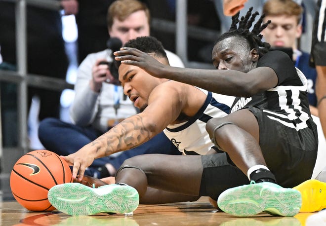 Feb 10, 2024; Indianapolis, Indiana, USA; Butler Bulldogs guard Pierre Brooks (21) and Providence Friars guard Garwey Dual (3) battle for the ball during the second half at Hinkle Fieldhouse. Mandatory Credit: Robert Goddin-USA TODAY Sports