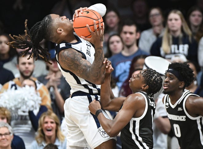 Feb 10, 2024; Indianapolis, Indiana, USA; Providence Friars guard Jayden Pierre (1) fouls Butler Bulldogs guard Jahmyl Telfort (11) on a shot during the second half at Hinkle Fieldhouse. Mandatory Credit: Robert Goddin-USA TODAY Sports