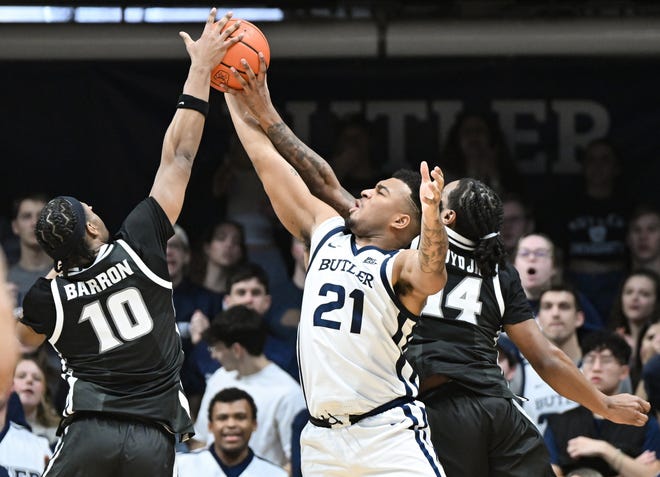 Feb 10, 2024; Indianapolis, Indiana, USA; Providence Friars forward Rich Barron (10) and guard Corey Floyd Jr. (14) battles Butler Bulldogs guard Pierre Brooks (21) for the ball during the second half at Hinkle Fieldhouse. Mandatory Credit: Robert Goddin-USA TODAY Sports